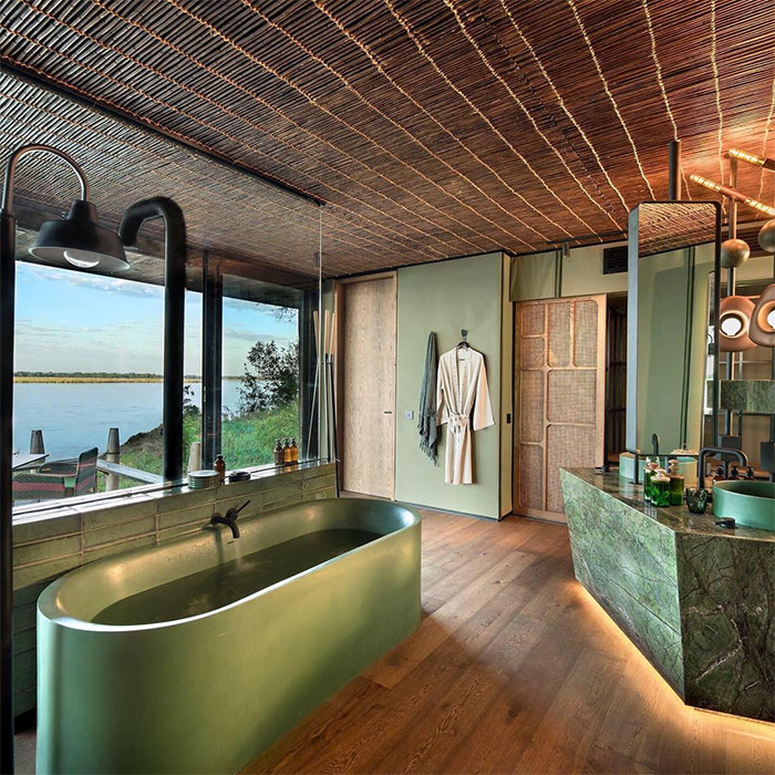 Bathroom with green bathtub and decorations