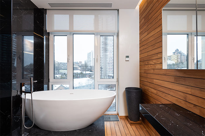 Bathroom with white bathtub and black marble decorations