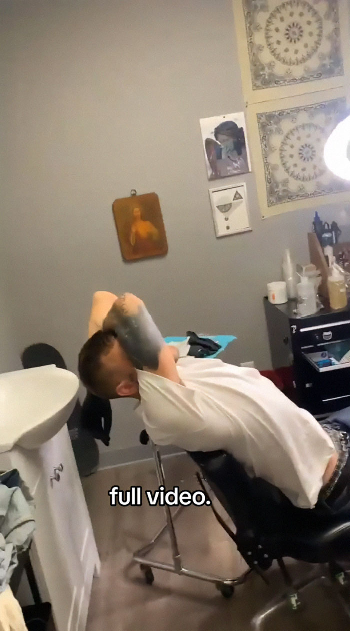 Tattoo artist in studio, reflecting on tattoo blunder seen on TikTok video. Tattoo artist in studio, reflecting on tattoo blunder seen on TikTok video.