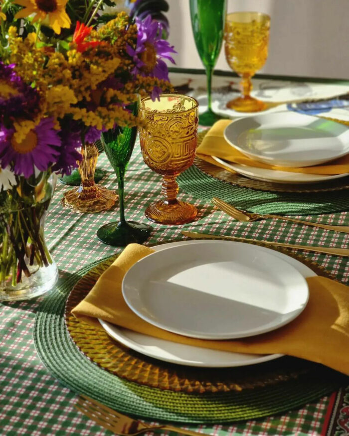 Dining table with colorful flowers and glasses on it