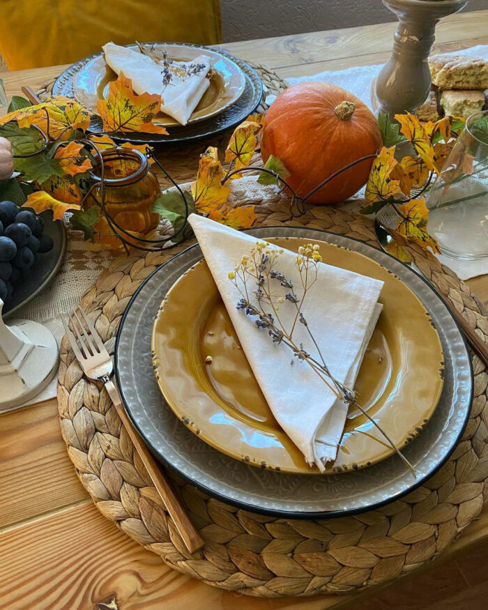 Pumpkin near yellow plate with napkin