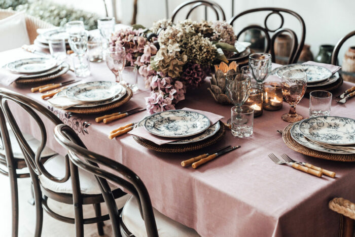 Table with pink tablecloth and floral decoration