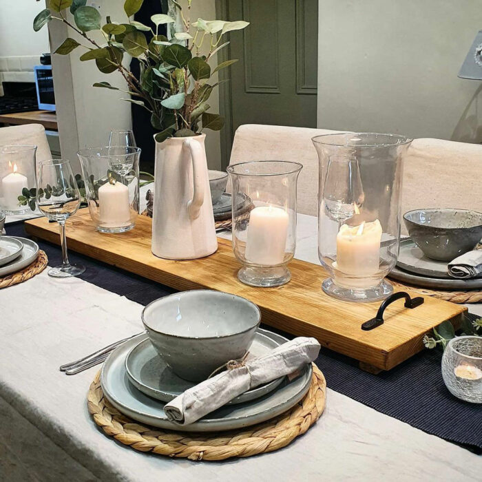 Wooden plank with candles and vase as a table runner
