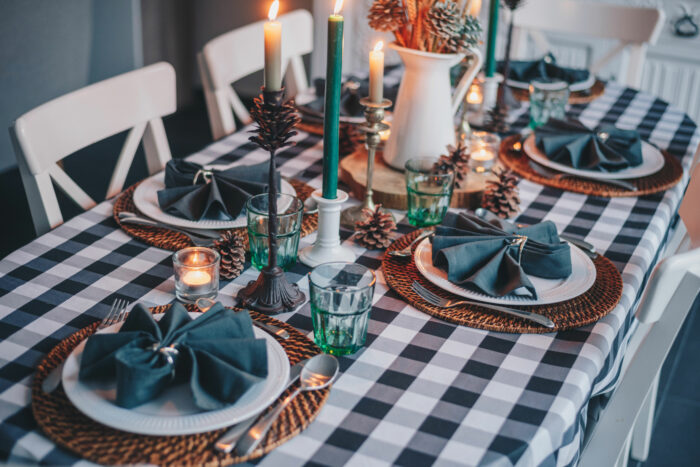 white candles on blue and white checkered tablecloth