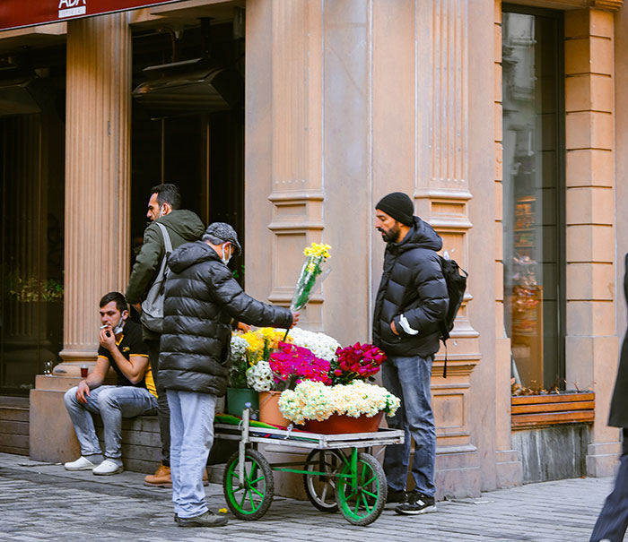 Man Buying Flowers at a Street Corner