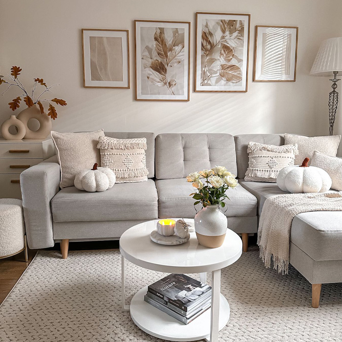 Grey couch with cushions, coffee table with flowers