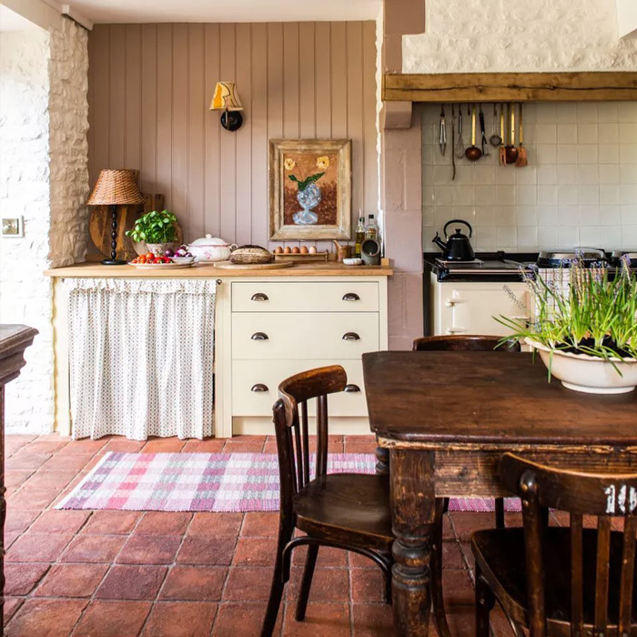 Brown dining table on the terracotta tiles in the kitchen 