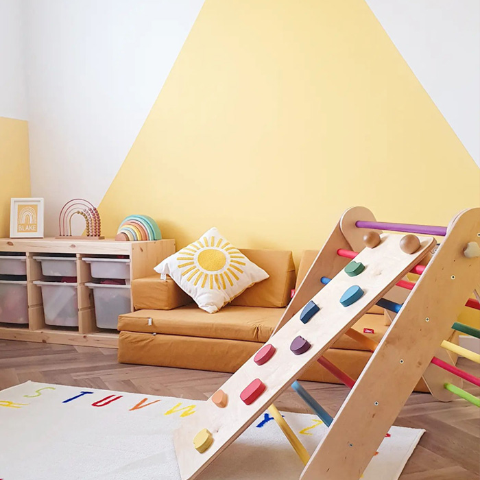 Yellow kid's playroom with toys and orange couch 