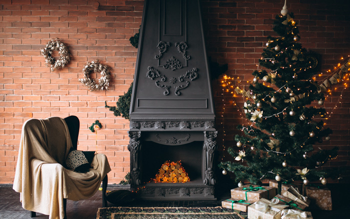 A living room with fireplace and Christmas tree