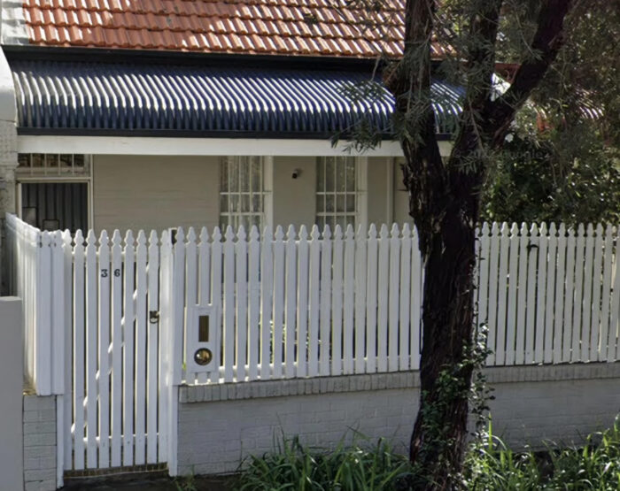 Closely spaced panels on a white picket fence