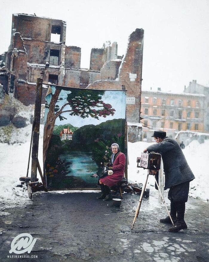 In November 1946, While Capturing A Portrait In Warsaw, A Photographer Employs A Personal Backdrop To Conceal The Remnants Of Poland's World War II Destruction