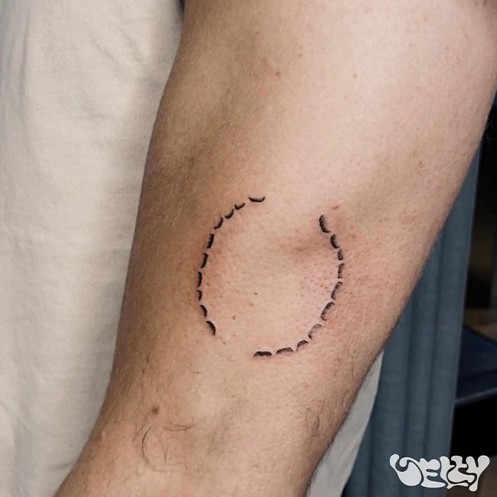 Man's arm showing a minimal circle tattoo symbolizing love for girlfriend. Man's arm showing a minimal circle tattoo symbolizing love for girlfriend.