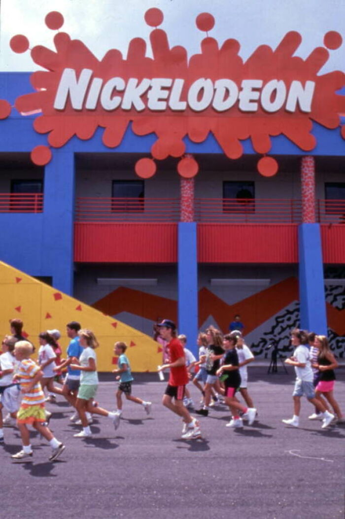 A Very 1990 Picture: Children Jogging Outside The Nickelodeon Studios Attraction Located At The Universal Studios Florida Amusement Park In Orlando, Florida, Circa 1990