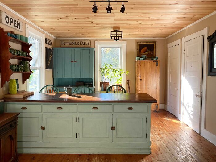 Soft pastel green kitchen with cabinets