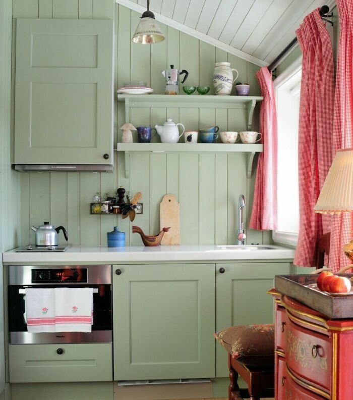 Small light green kitchen with green cabinets