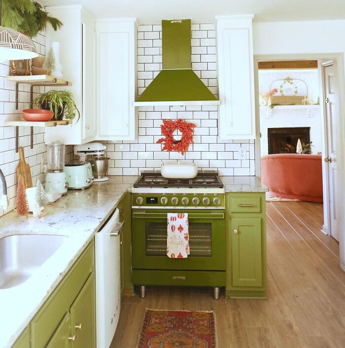 Green kitchen with green cabinets and marble countertops