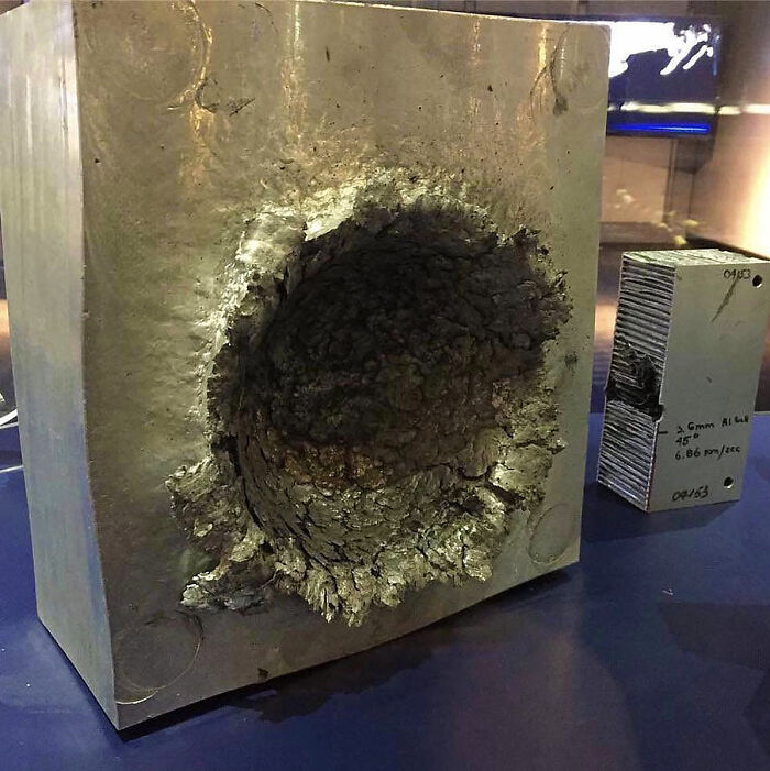 This Is What Happens To Aluminum When A 1/2 Oz Piece Of Plastic Hits It At 15,000 Mph In Space
