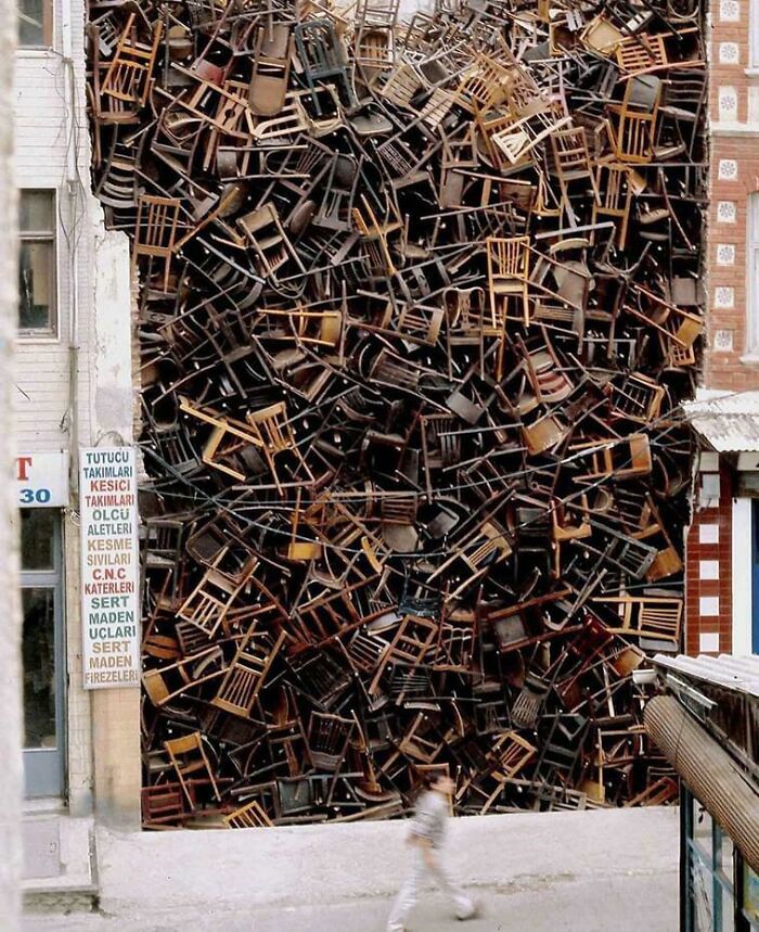 “1550 Chairs Stacked Between Two City Buildings”, Istanbul, Turkey. See More: Themindcircle.com/Urban-Art-Installations/