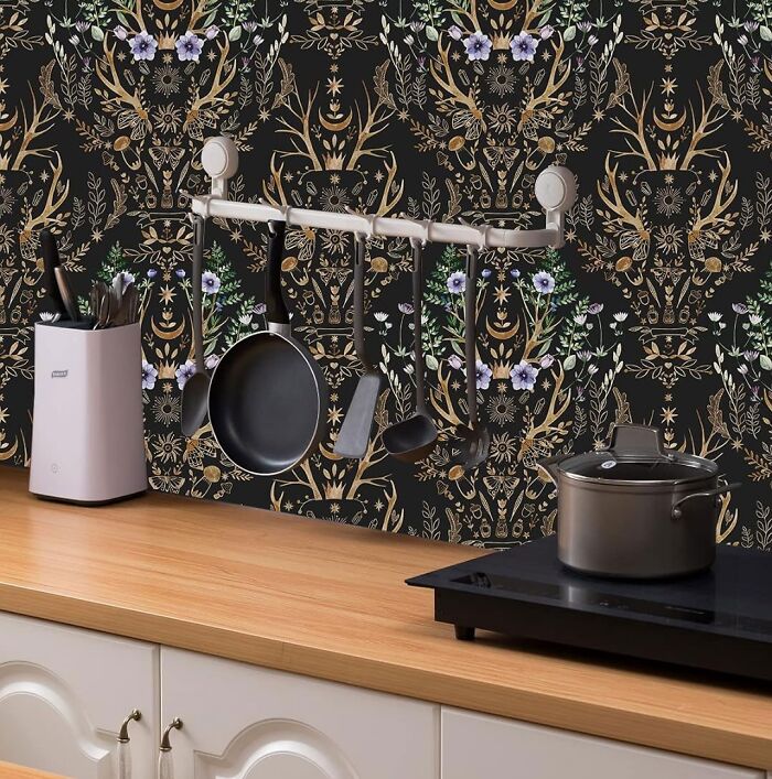 Kitchen with black renaissance flower wallpaper and white cupboards
