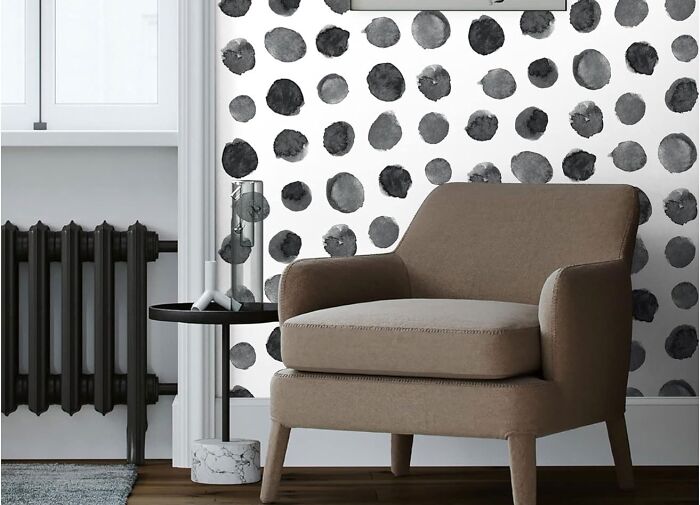Room with dalmant looking self adhesive mural wallpaper and chair
