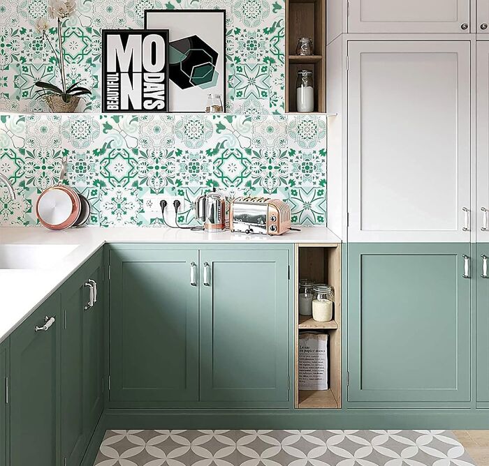Kitchen with green Moroccan wallpaper with green and white cupboards