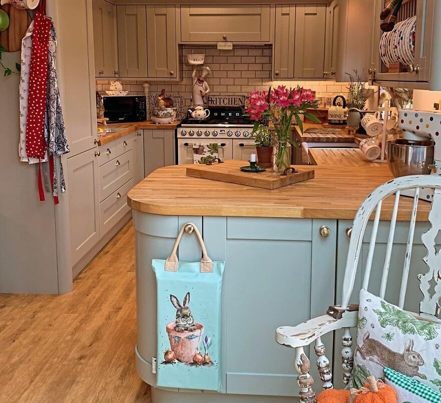 A lot of kitchen items in cottage kitchen with grey and turquoise cabinets