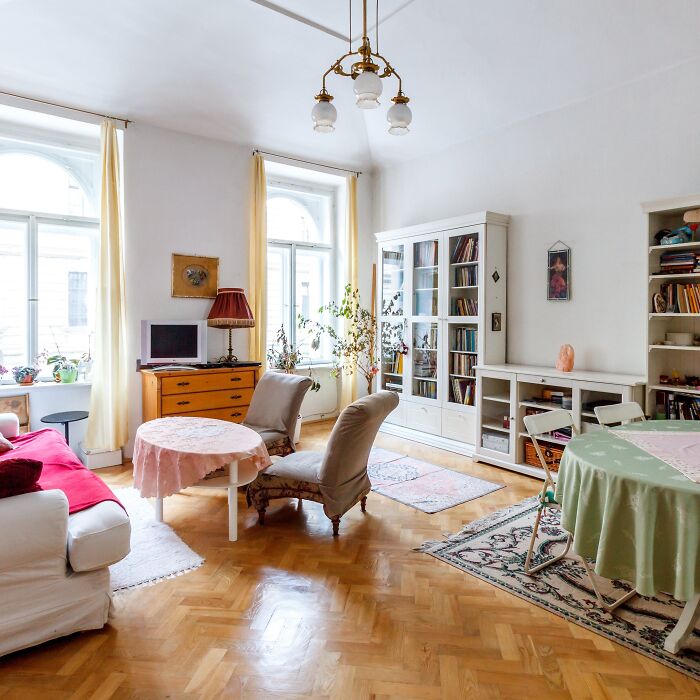 White dining room featuring various tables and chairs, showcasing inspiring dining room ideas for family gatherings and parties