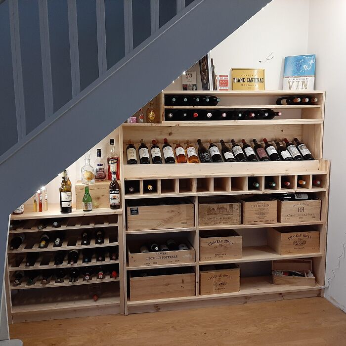 Dining room wine rack storage with bottles and wooden crates, creating inspiring ideas to beautify family gatherings and parties.