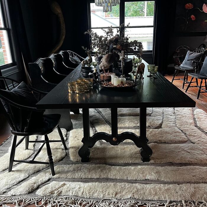 Dark dining room with black table and chairs featuring stylish decor for inspiring dining room ideas and family gatherings.