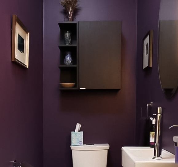 Dark purple bathroom with black cabinet and wall art