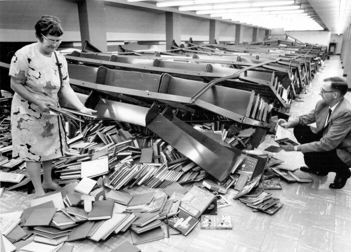 The Librarian At Lorain Ohio, Public Library Is Looking At The 50,000 Book Chaos After One Shelf Fell Over, The Rest Fell Like Dominoes, 1971