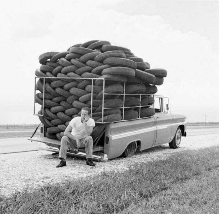 A Man Experiences Irony As His Car, Laden With Used Tires, Has A Flat Tire, Houston, Texas, 1966