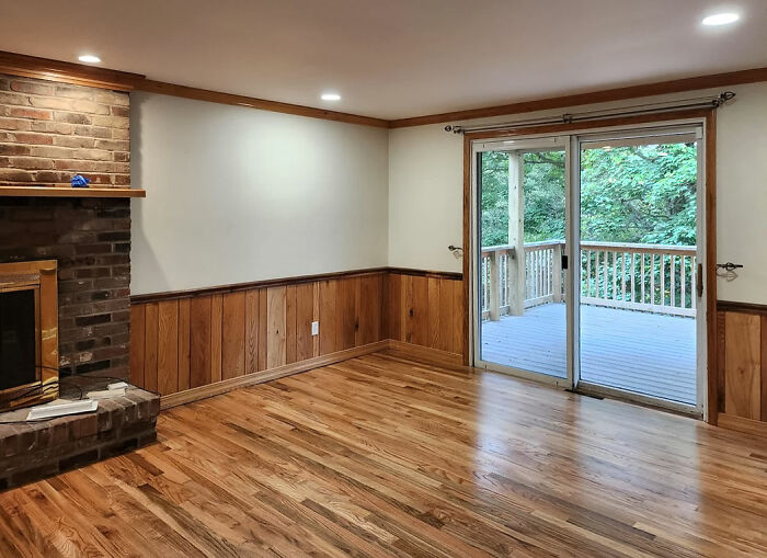 Living room with fireplace, wooden flooring and wood wainscoting