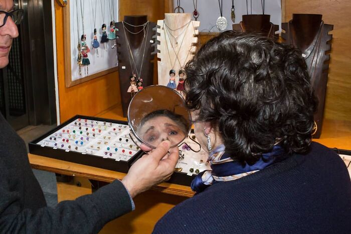 A Photograph Of A Woman Buying Earrings