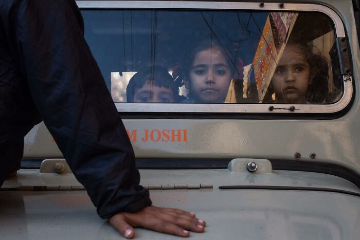 A Photograph Of Kids In A Car
