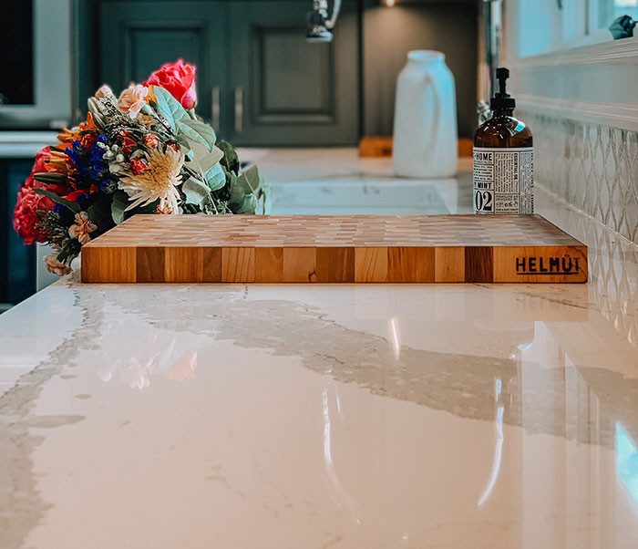 Photo of kitchen countertop and cutting board with flowers on it. Photo of kitchen countertop and cutting board with flowers on it.