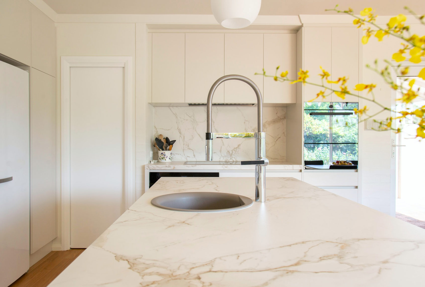 Light sand color kitchen with veined concrete countertop