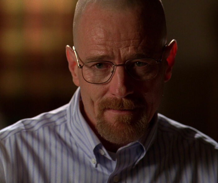 Walter White wearing gray shirt looking from Breaking Bad