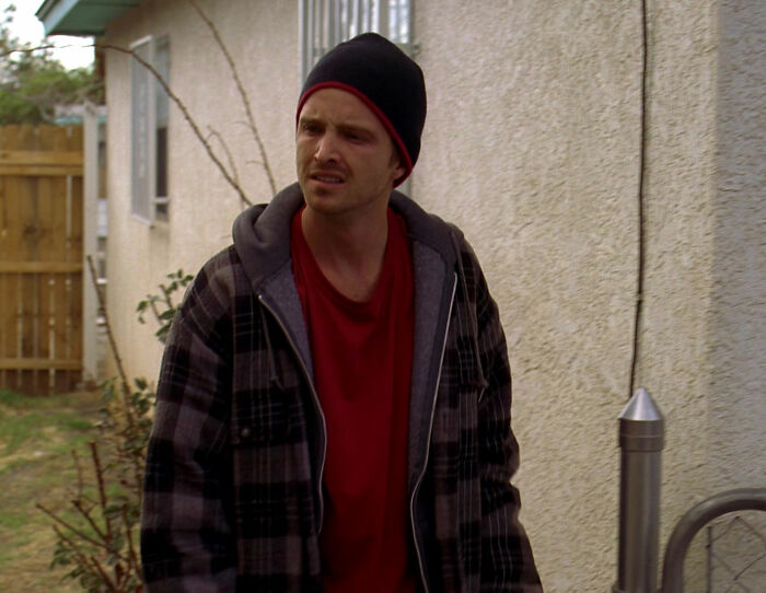 Jesse wearing red shirt and walking from Breaking Bad