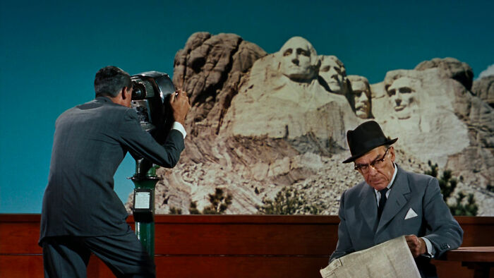 Persons reading and looking at Mount Rushmore in North By Northwest