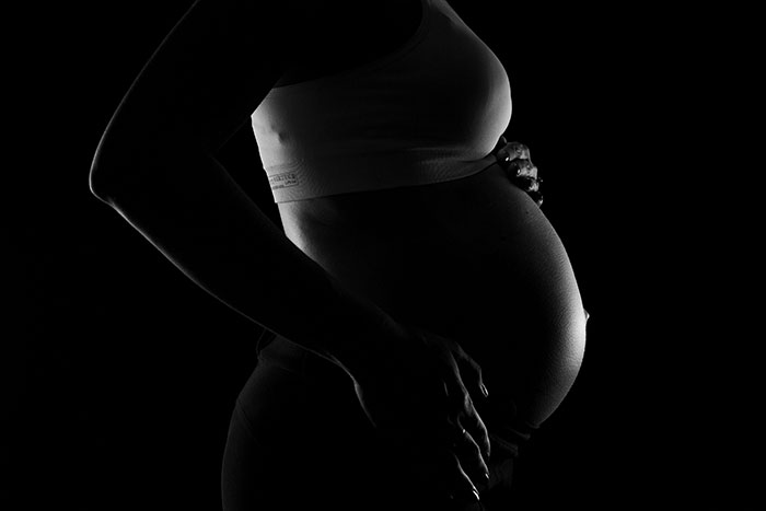 Black and white photo of pregnant woman