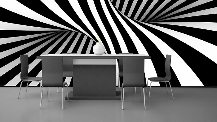 Room with black table with chairs and optical illusion wallpaper