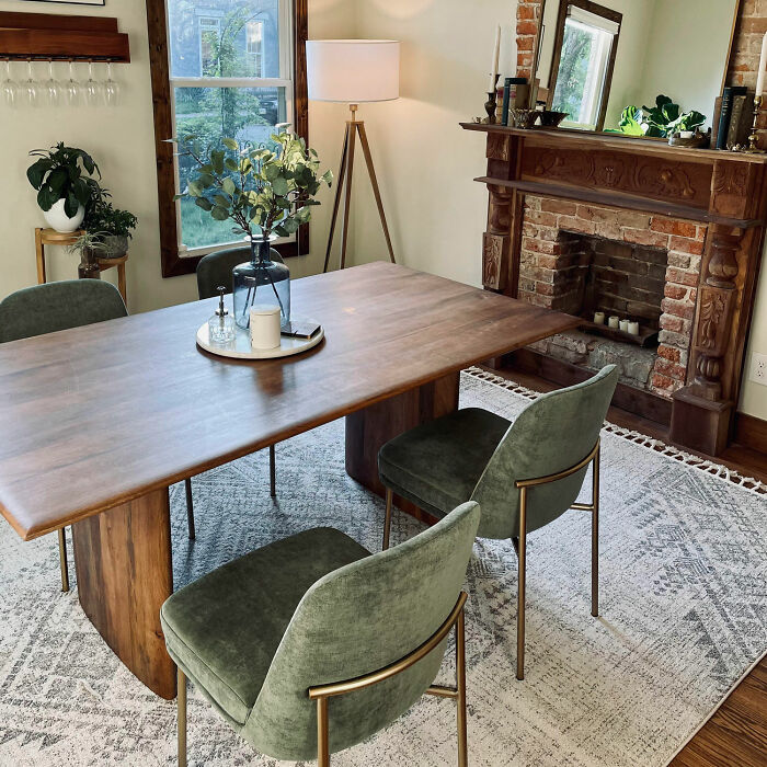 Dining room with wooden table, green chairs, and fireplace showcasing inspiring dining room ideas for family gatherings and parties.