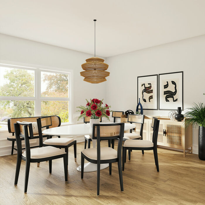 Bright dining room with white table and chairs, abstract wall art, and natural light, showcasing inspiring dining room ideas.