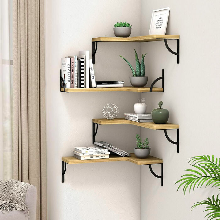 Floating corner shelves in a dining room, styled with books and plants to inspire dining room ideas for family gatherings.