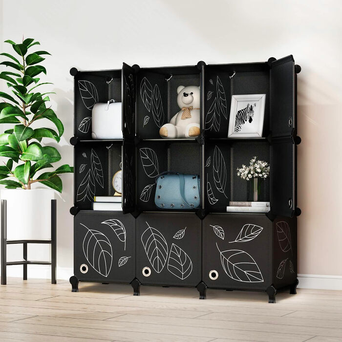 Black storage unit with leaf patterns in a stylish room, perfect for organizing and beautifying dining room spaces.