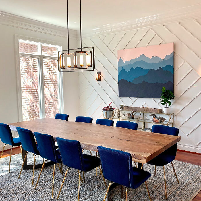 Modern dining room with wooden table and blue chairs showcasing stylish dining room ideas for family gatherings and parties.