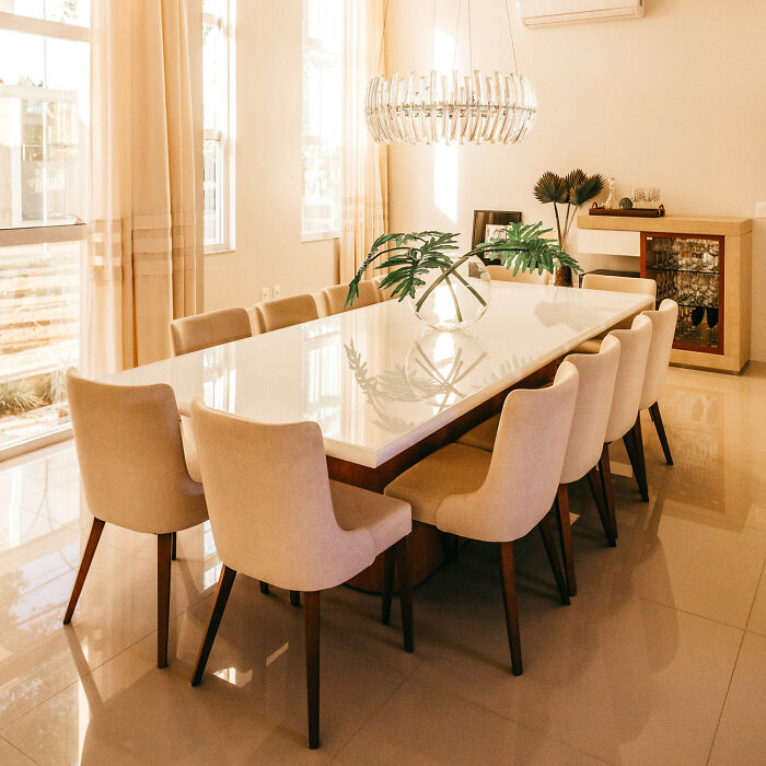 Bright dining room with white table and chairs showcasing inspiring dining room ideas for family gatherings and parties.