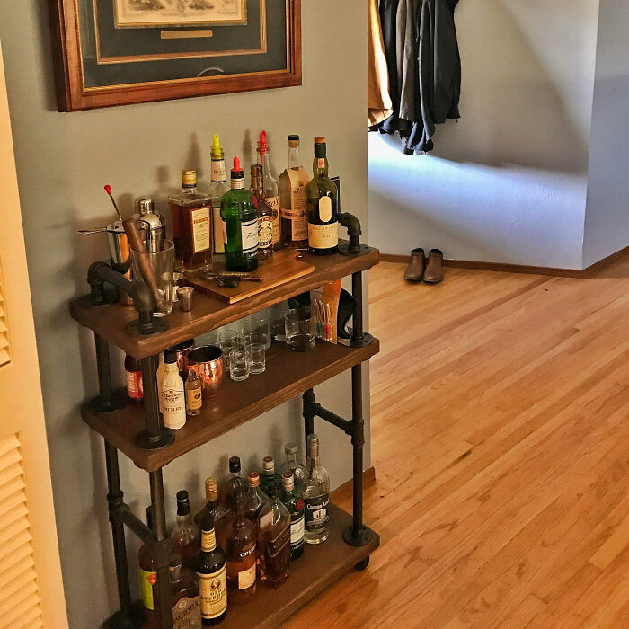 Dining room minibar setup with various drinks and glassware enhancing dining room ideas for family gatherings and parties.