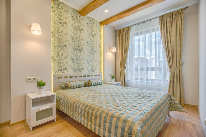 Big bed with light green and yellow colors cover